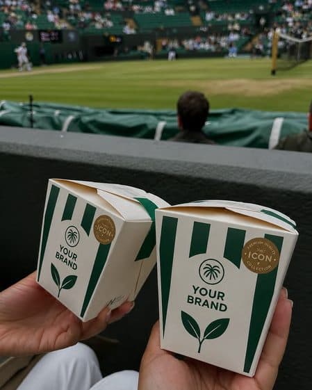 Two branded takeaway boxes held up courtside