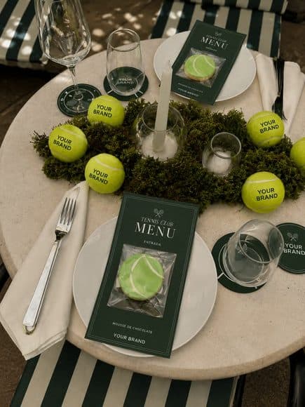 A place setting with a branded menu and tennis-ball details